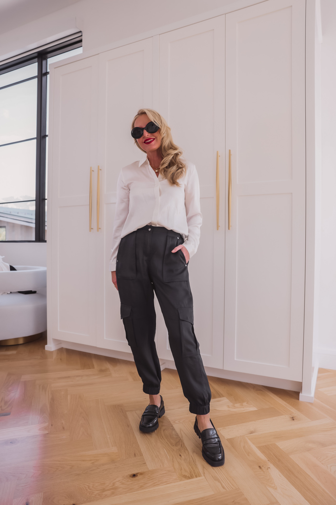 How to wear loafers, how to style loafers, what to wear with loafers, how to wear loafers women, womens loafers, stylish outfits with loafers, loafer outfits, what to wear with loafers women, how to wear loafers 2023, how to wear loafers casually, erin busbee, busbee style, fashion over 40, dolce vita black loafers, loewe oval sunglasses, monica vinader jewelry, white silky frame button down shirt, black cinq a sept giles joggers